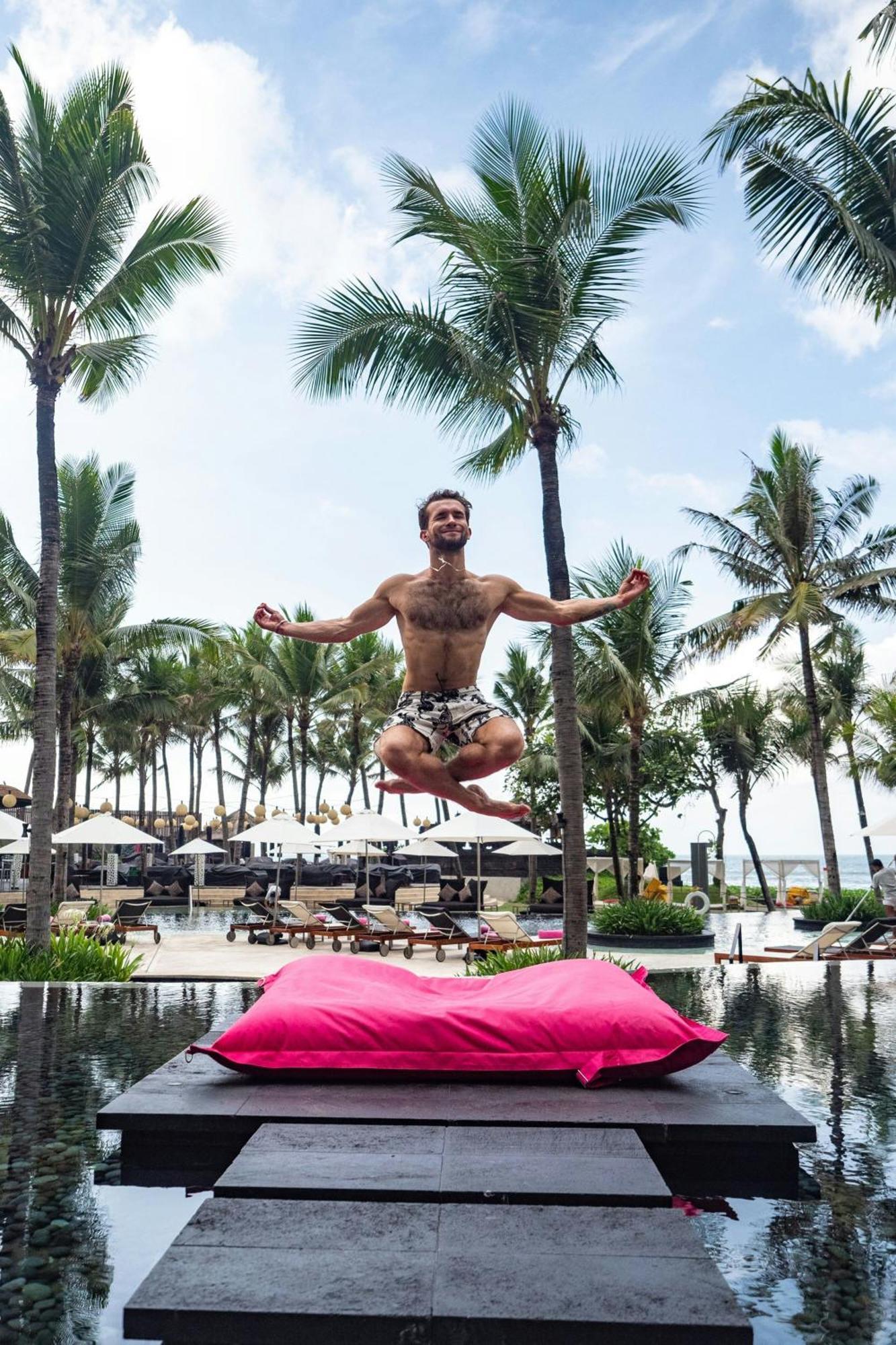 W Bali - Seminyak Hotel Exterior photo A man jumping on a pink bean bag
